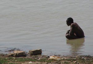 Pooping in the river, Mopti, Mali